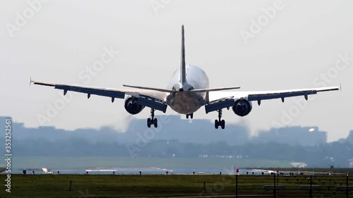 Big Airliner is landing on runway at HAM Hamburg Airport Germany at daytime