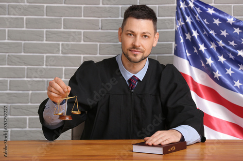 Male judge at table in cour...