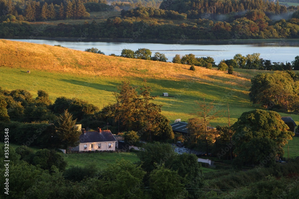 Farm cottage and surrounding countryside consisting of tree-lined fields,  on shores of Lough Gill, Kilmore, County Leitrim, rural Ireland