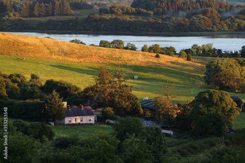 Farm cottage and surrounding countryside consisting of tree-lined fields, on shores of Lough Gill, Kilmore, County Leitrim, rural Ireland