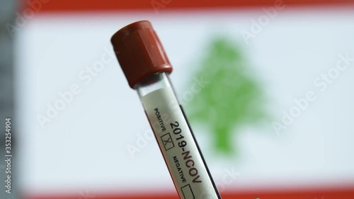 Corona virus or Covid-19 in Lebanon , sample blood tube with Lebanon flag on background