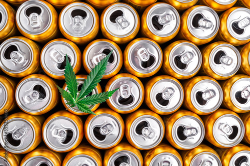 Golden beer cans.The sale of products and drinks with addition of hemp (cannabis) Beer cans with weed on one of them photo