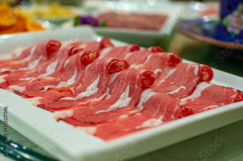 Thin slices of beef meat, ready to be cooked in hot pot, popular Chinese dish