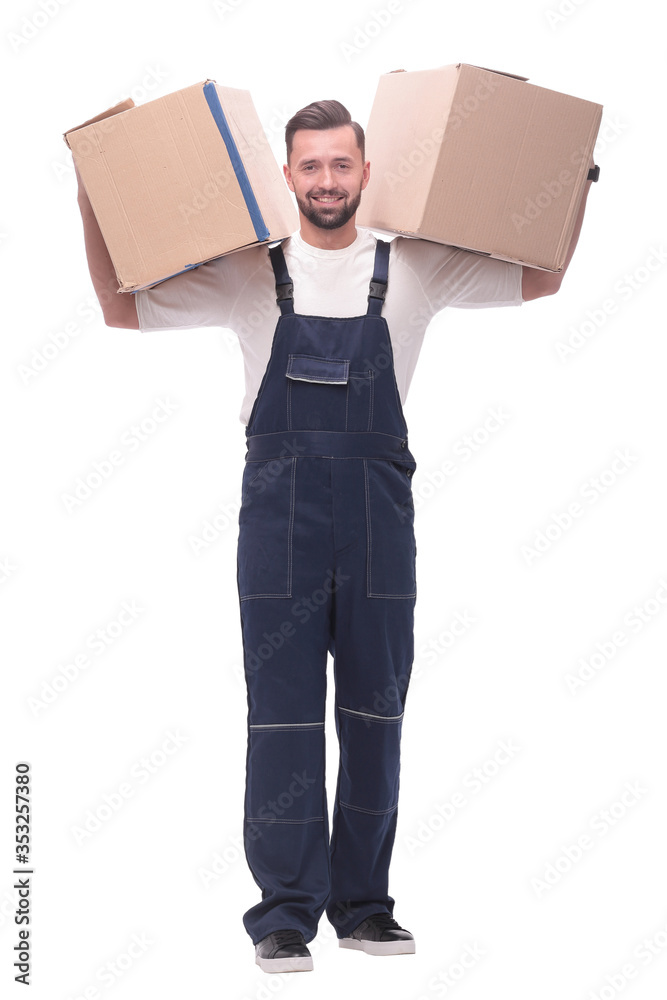 in full growth. a smiling man with cardboard boxes on his shoulders in full growth. a smiling man with cardboard boxes on his shoulders