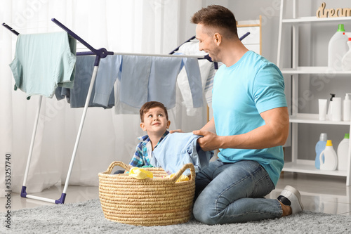 Man and his little son doin...