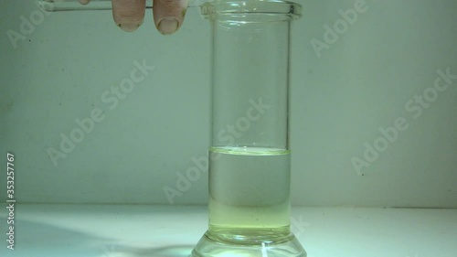 Precipitation reaction where two solutions are mixed din a glass. A potassium iodide solution is added to a lead nitrate solution, a chemical reaction takes place. A  yellow precipitate appears. 