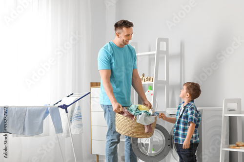 Man and his little son doin...
