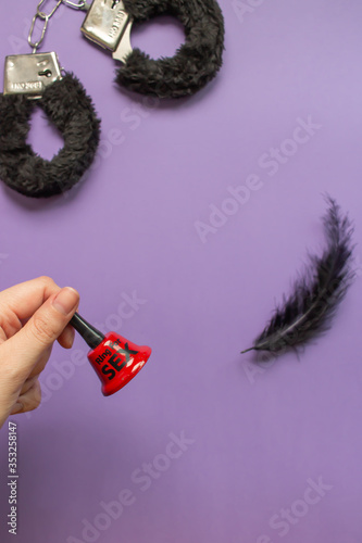 Different sex toys are on a purple background. Idea for sex shop advertising. Adult content.