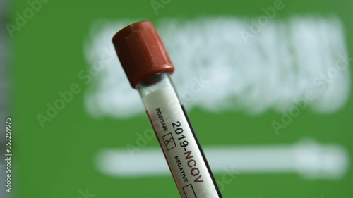 Corona virus or Covid-19 in Saudi Arabia, sample blood tube with Saudi Arabia flag on background
