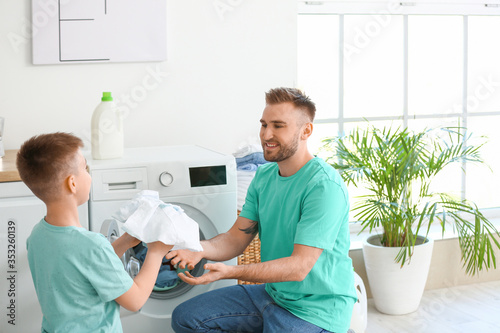 Man and his little son doin...