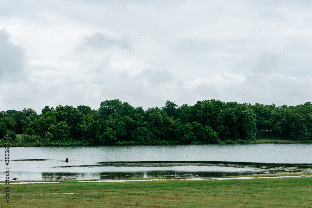 Serene waterfront view in Anna, Texas, on an overcast spring afternoon. Anna is a northern suburb of the Dallas Fort-Worth Metroplex. Serene waterfront view in Anna, Texas, on an overcast spring afternoon. Anna is a northern suburb of the Dallas Fort-Worth Metroplex.