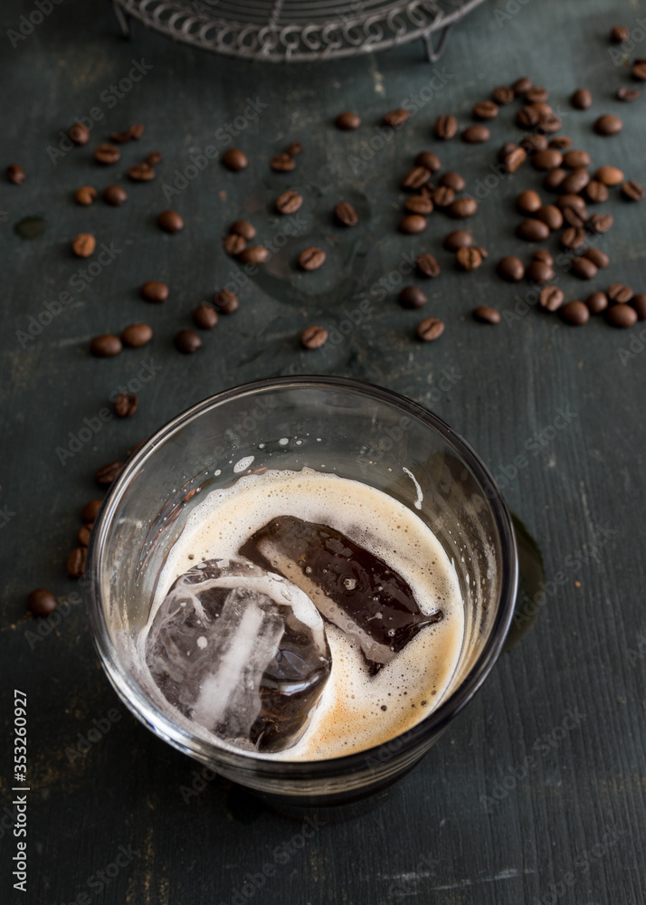 Two ice cubes in a cup of tasty coffee. Two ice cubes in a cup of tasty coffee.