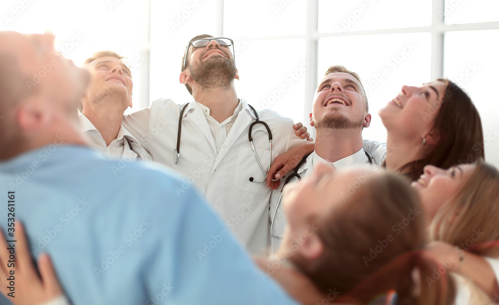 Fototapeta premium close up. group of happy doctors standing in a circle