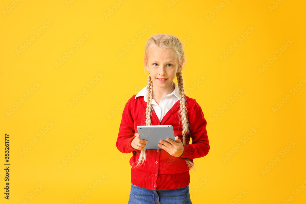 Cute little girl with tablet computer on color background. Concept of online education Cute little girl with tablet computer on color background. Concept of online education