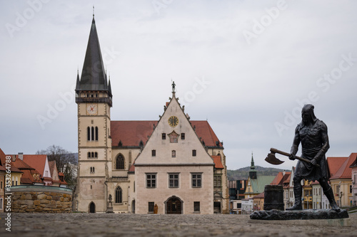 Executioner statue on main square of Bardejov,  St. Aegidius Basilica in background, Bardejov, Slovakia. The town Bardejov is UNESCO World Heritage Site © ventura