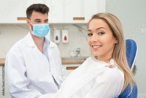 Young woman sitting on chair at dentist office