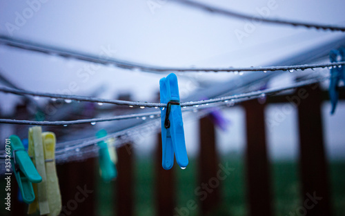 Clothes pegs on a wet clothes line