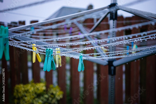 Clothes pegs on a wet clothes line