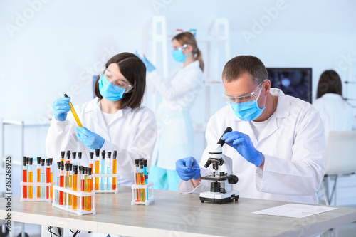 Scientists working in modern laboratory