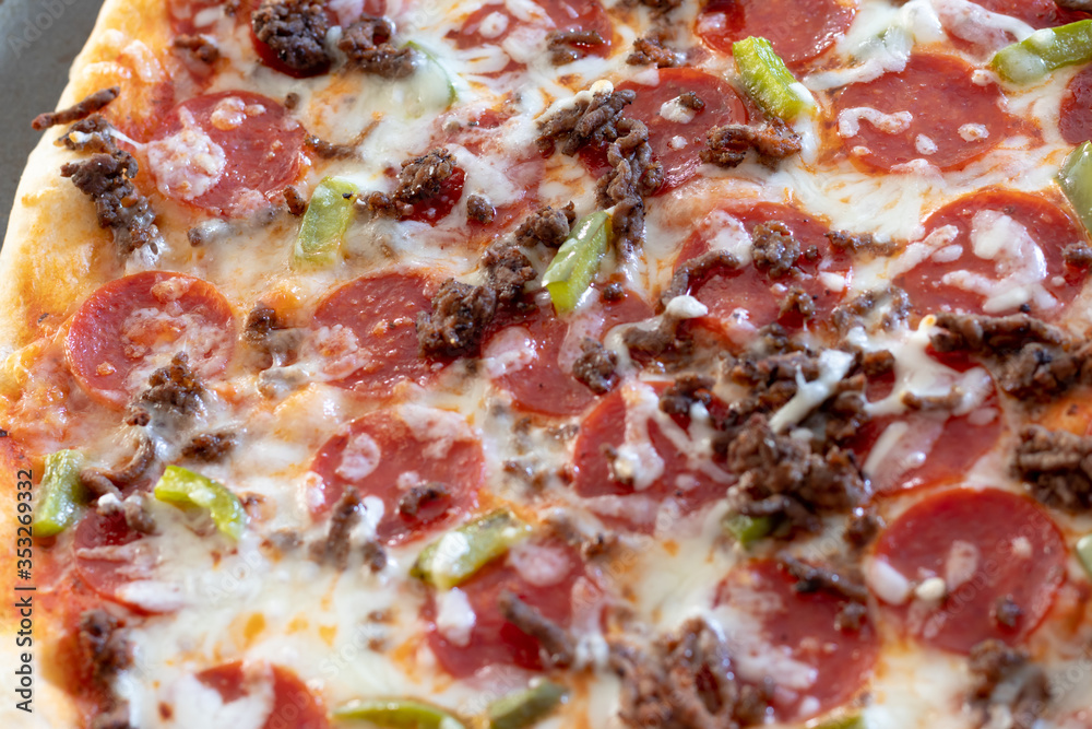 Homemade pizza fresh from the oven and unsliced. Topped with pepperoni, cheese, peppers, onions, and beef. Homemade pizza fresh from the oven and unsliced. Topped with pepperoni, cheese, peppers, onions, and beef.