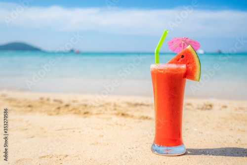 Watermelon juice in drink glass on the beach with clear day sky in Koh Kood at Trat, Thailand. Summer, Travel, Vacation and Holiday. Relax and traveling at sea concept..