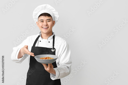 Handsome Asian chef with di...