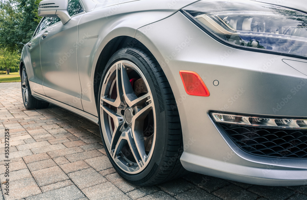 Close up on beautiful sports car in driveway. Close up on beautiful sports car in driveway.