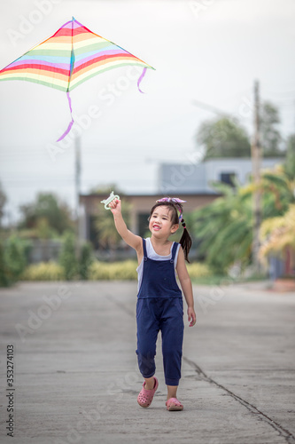 Close-up view of cute girl playing with sports (kite sport), learning outside the classroom during the summer semester and making good use of leisure time.