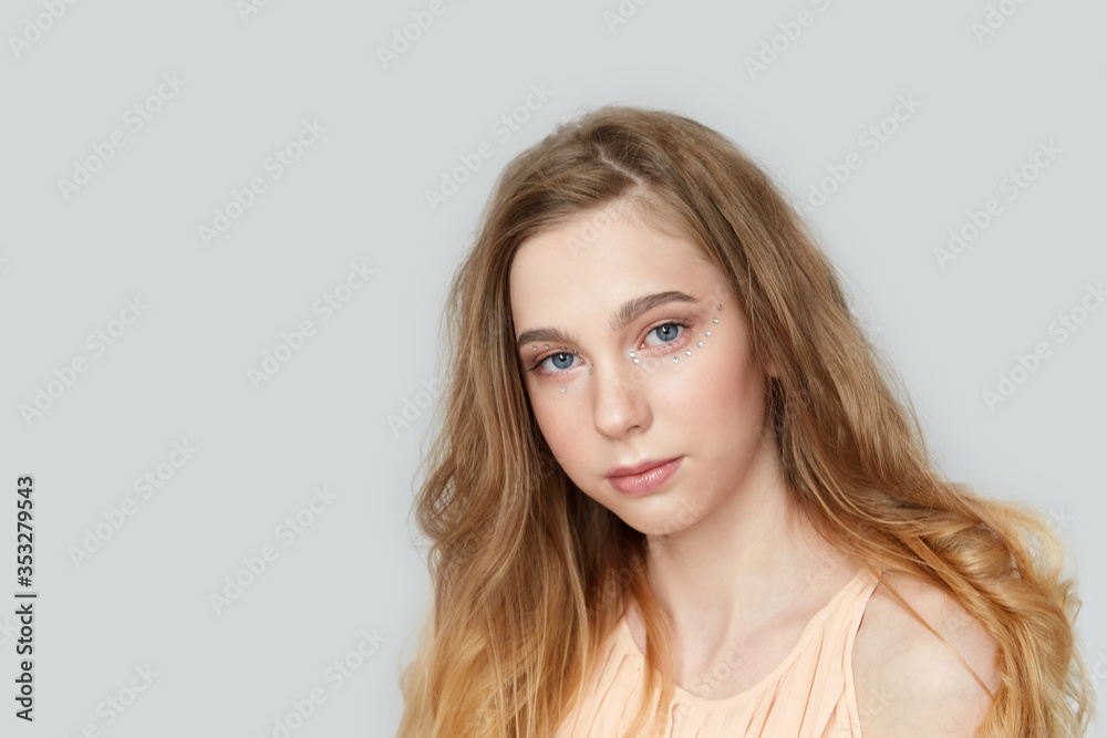A young beautiful girl with blue eyes and long blond hair. A young beautiful girl with blue eyes and long blond hair.