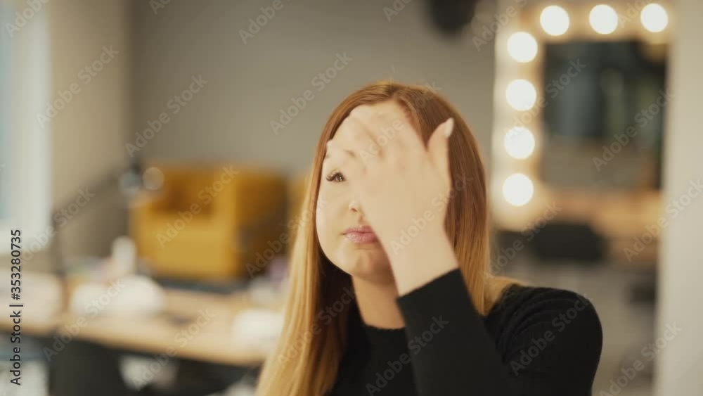 close-up of a young beautiful girl examines and admires herself in the mirror close-up of a young beautiful girl examines and admires herself in the mirror