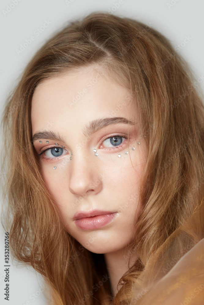 A young beautiful girl with blue eyes and long blond hair. A young beautiful girl with blue eyes and long blond hair.