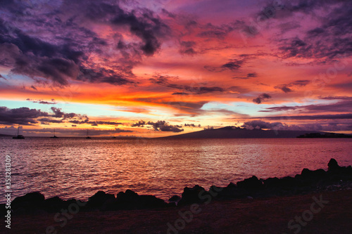 Dramatic sunsetn with fiery sky from Maui with Molokai in the distance. photo