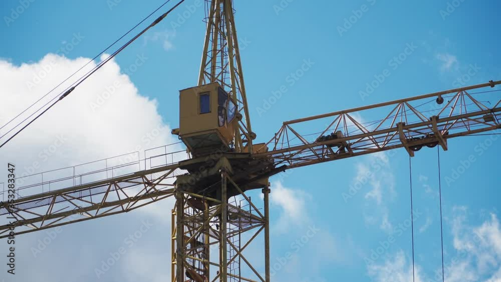 Big industrial construction crane with beautiful cloudy sky background. City development Big industrial construction crane with beautiful cloudy sky background. City development