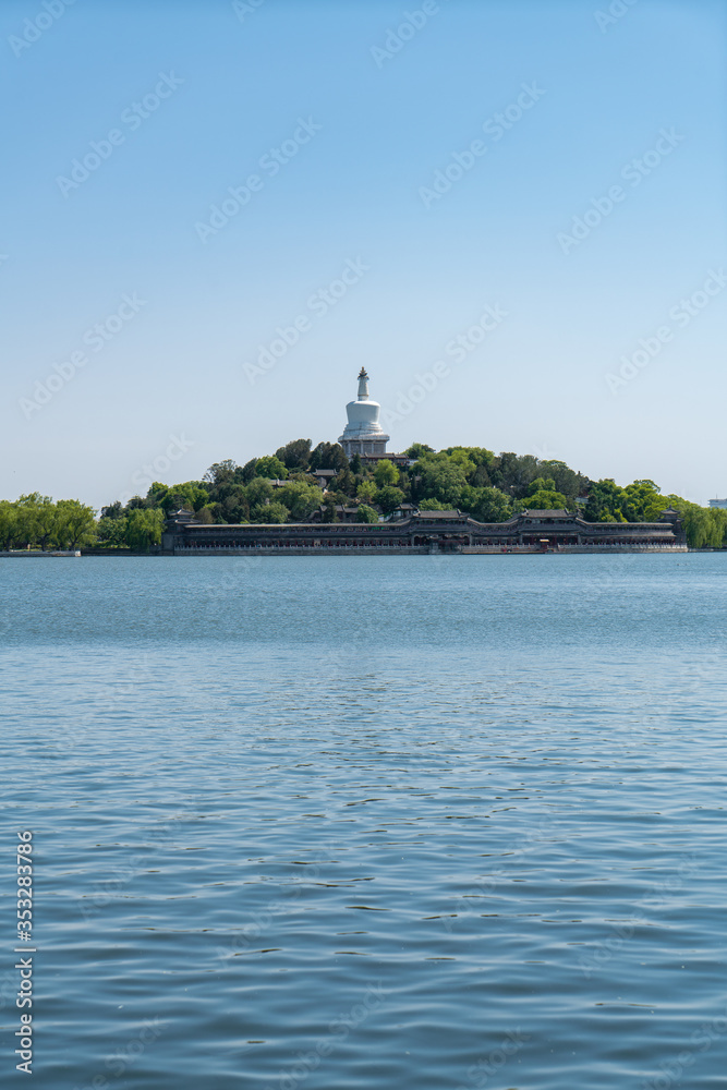 Qionghua island with White Pagoda and lake water in Beihai park, Beijing, China.
