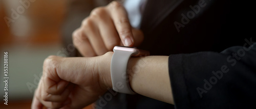 Cropped shot of a female using smartwatch to check messages