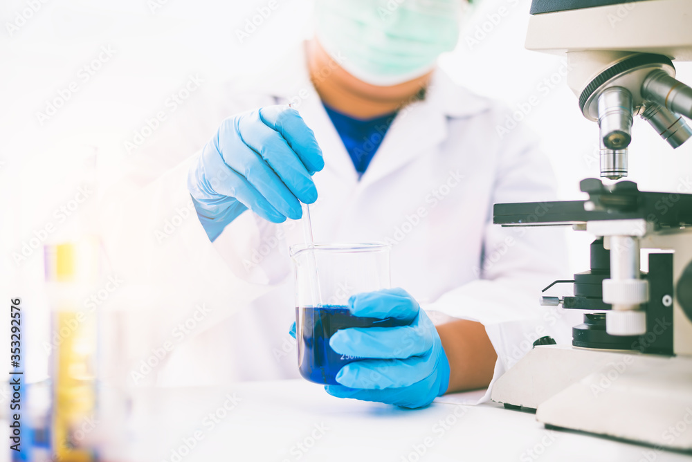 Equipment and science experiments oil pouring scientist with test tube blue making research in laboratory. Equipment and science experiments oil pouring scientist with test tube blue making research in laboratory.