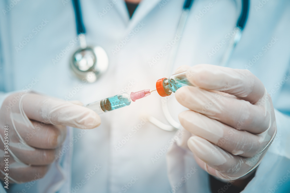 Doctor with syringe ready for injection of vaccine to patient. Vaccination concept. Doctor with syringe ready for injection of vaccine to patient. Vaccination concept.