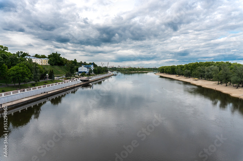 Beautiful view from the bridge to the Sozh River and the embankment in a green park. Gomel. Belarus
