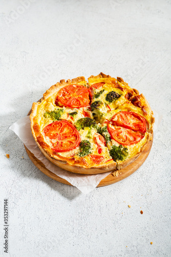Savory tart with broccoli on white surface, healthy food