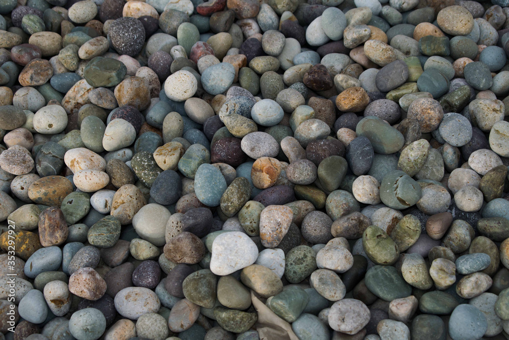 Colourful smooth beach rocks or pebbles. round pebbles piled together Colourful smooth beach rocks or pebbles. round pebbles piled together