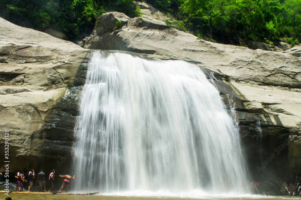 Tourist flock at the Tangadan falls in La Union Pangasinan Philippines. Big rock formations