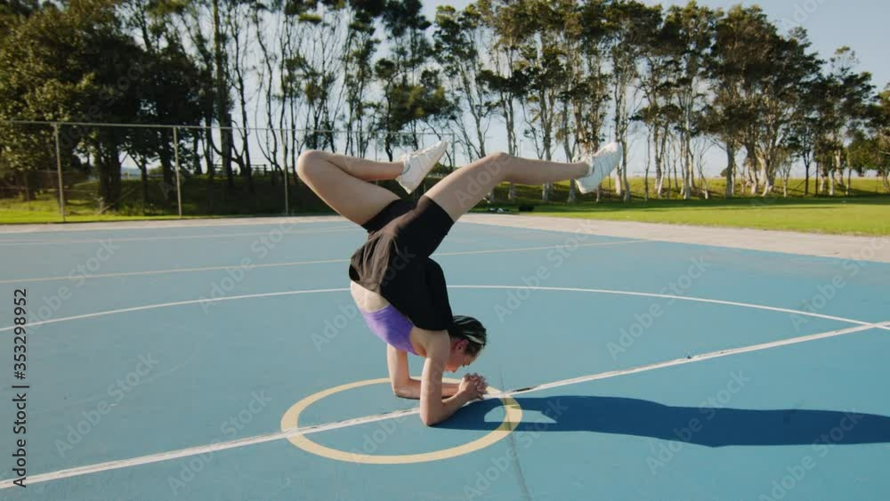 Young Woman Poses in Hollow Back Handstand on Sunny Morning. Wide Shot Young Woman Poses in Hollow Back Handstand on Sunny Morning. Wide Shot