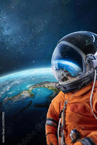 Fototapeta Naklejka Na Ścianę i Meble -  Spaceman and Earth planet behind. Astronaut on orbit. View from ISS. Elements of this image furnished by NASA