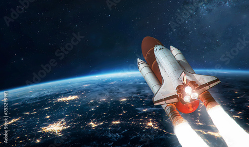 Fototapeta Naklejka Na Ścianę i Meble -  Space shuttle on orbit of Earth planet. Rocket launch in outer space. Deep space and cities lights. .Elements of this image furnished by NASA