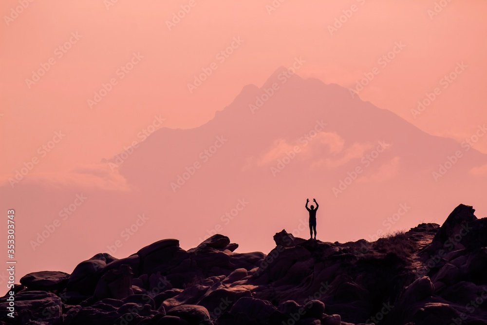 Silhouette of a man on the top of the mountain