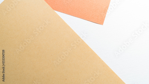 Colorful pastel paper stacks background. Abstract white beige copper brown colors. Minimalism geometric flat lay backdrop. Top view