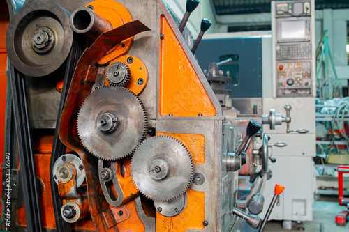 close up modul gear of  lathe machine paint orange background in factory photo