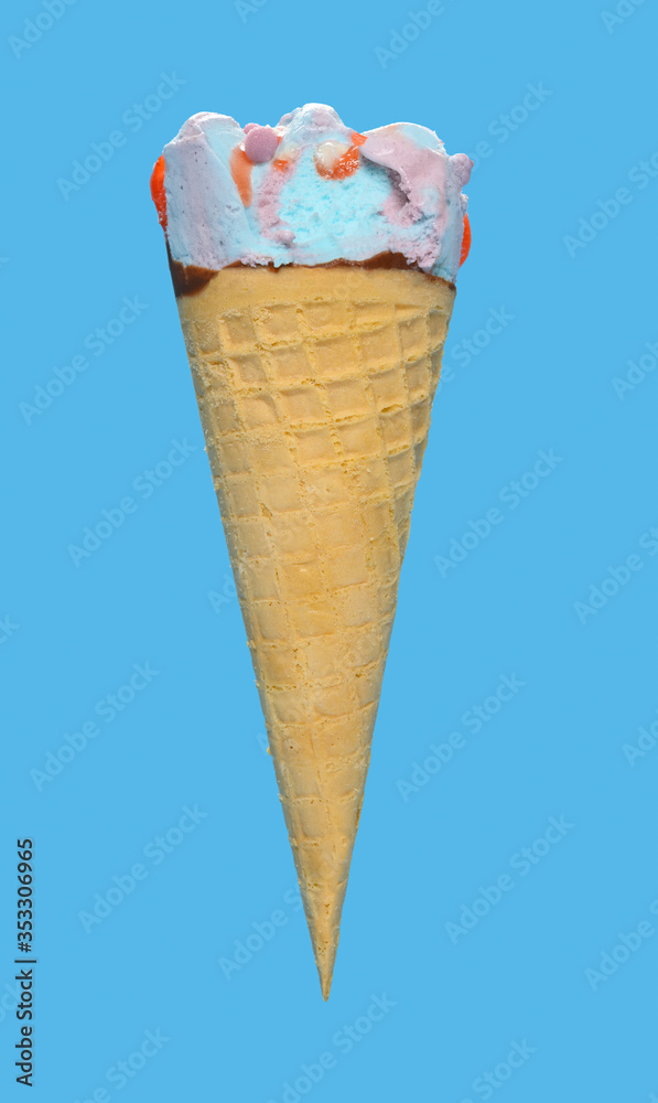 side view marshmallow and raspberry flavor ice cream cone with a small bite on blue background side view marshmallow and raspberry flavor ice cream cone with a small bite on blue background