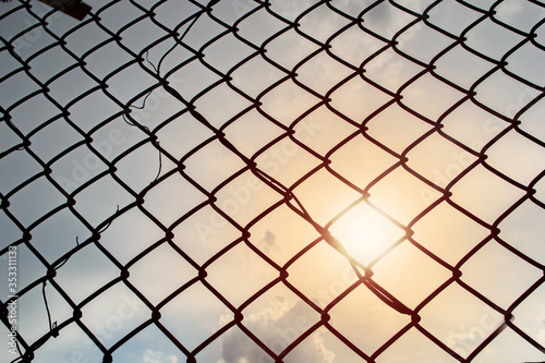wire fence , lighting sun background