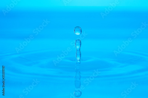 splash of blue water drop on a blue background close-up